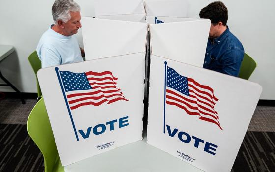 People mark their ballots at the polling place at Tysons-Pimmit Regional Library in Falls Church, Va., Oct. 31. (AP/Stephanie Scarbrough)
